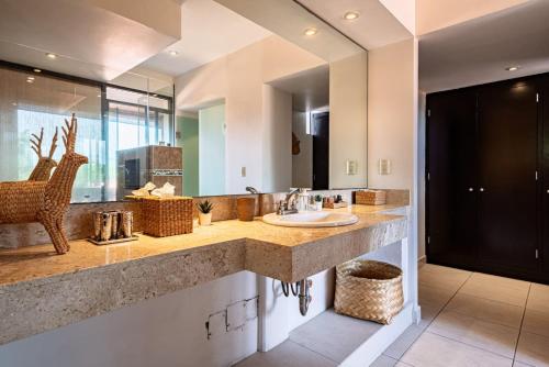 a bathroom with a sink and a large mirror at Majestic Colonial Villa Private Pool Jacuzzi and Gardens in Ocotepec