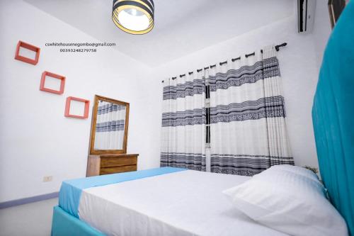 a bedroom with a bed and a window at Cs white house negombo in Negombo