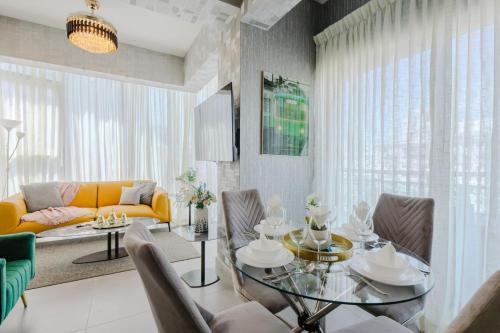 a living room with a table and a yellow couch at Chic Elegant City Center Condo in La Julia