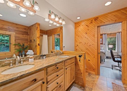a bathroom with two sinks and a large mirror at Mid-Century Decor Cabin with Stunning Views in Clyde