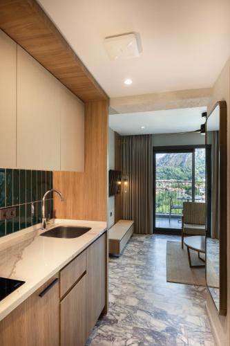 a kitchen with a sink and a large window at Club Aquarium in Marmaris