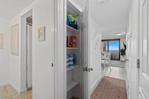 a hallway with white walls and white shelves at Jetty East, Paradise Palms, Sleeps 4, Pool Private Beach in Destin