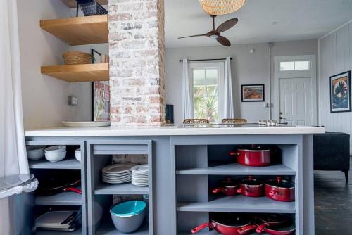 a kitchen with a counter with red pots and pans at Historic and charming duplex in desirable midtown, close to the beach and strand in Galveston