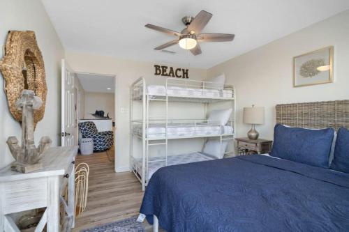a bedroom with a bed and a ceiling fan at Secluded beachfront house with gorgeous ocean views in Galveston