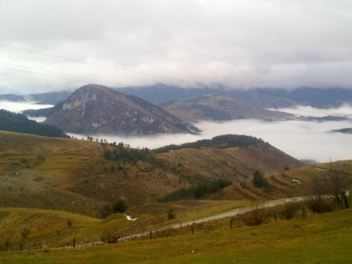 a view of a mountain with clouds in a field at Guest House Chala in Chala