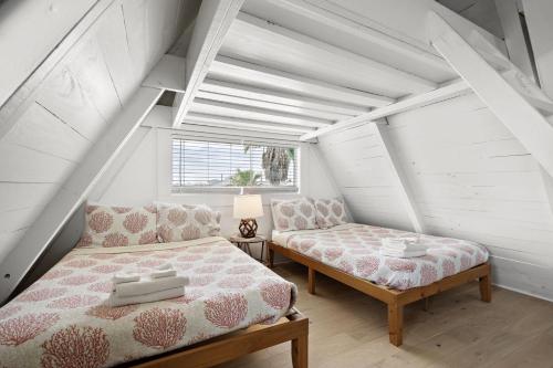 a bedroom with a bed and a couch and a window at Cozy A-frame with Fenced Yard, Fire Pit, Gulf View in Surfside Beach