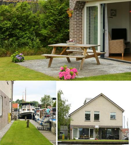 a picnic table and a house and a house with a boat at Appartement Hoek in Giethoorn