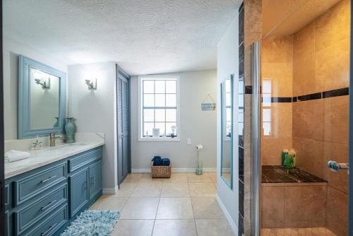 a bathroom with a sink and a shower at Seawall Sunrise-Close to Beach in Galveston