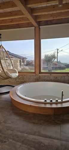 a large bath tub in a room with a window at Casa Carballo in Puxedo