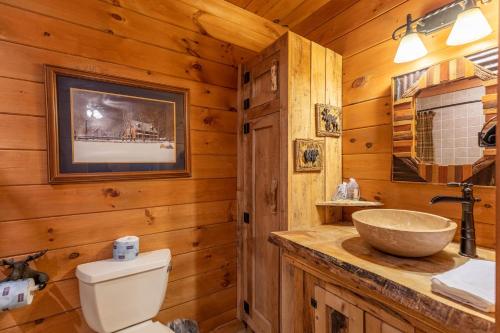 a bathroom with a toilet and a sink at Beary Relaxing Cabin in Banner Elk