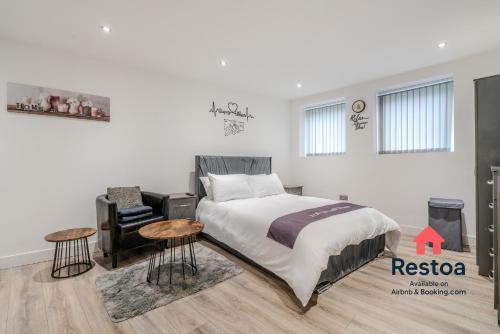 a bedroom with a bed and two tables at Neepsend Lane Studios in Neepsend