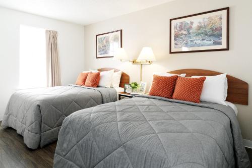 a hotel room with two beds and a window at InTown Suites Extended Stay Houston TX - West Oak in Houston