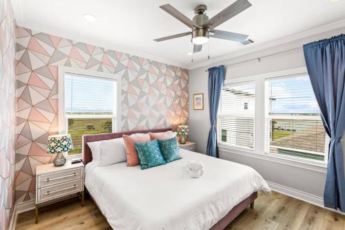a bedroom with a bed and a ceiling fan at Family Friendly 3-Bedroom Coastal Escape in Galveston