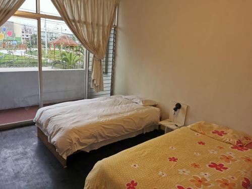 a bedroom with two beds and a large window at B&B Villamar Chorrillos in San Antonio