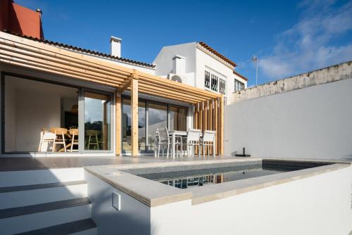 a swimming pool on the roof of a house at Figueiras House Pópulo Beach in Ponta Delgada