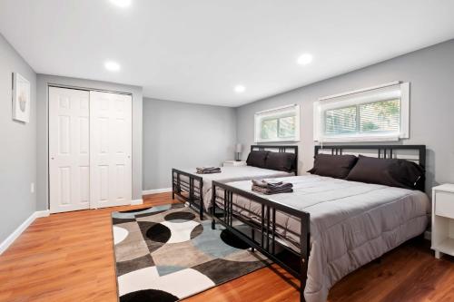a bedroom with two beds and a rug at Sensation on Salisbury in Pittsburgh