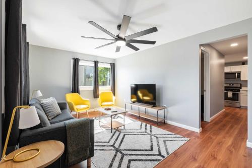 a living room with a couch and a tv at Sensation on Salisbury in Pittsburgh