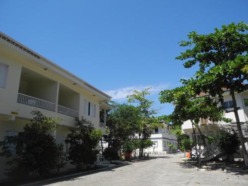 a street in a town with trees and buildings at Pousada e Camping Lagoa da Conceição in Florianópolis