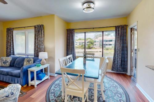 a dining room with a blue table and a couch at Anchorage 7449 in Hilton Head Island