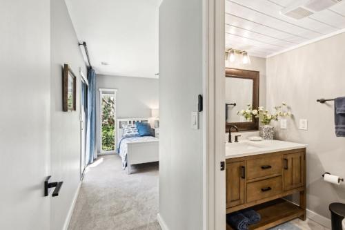 a bathroom with a sink and a bedroom with a bed at Beautifully remodeled 2 bedroom 2 bathrooms on the Marsh side of the resort in Franklintown