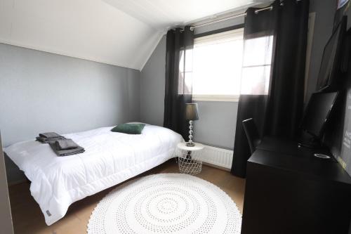 a bedroom with a white bed and a window at Luxury Apartment in the Heart of Pello in Pello