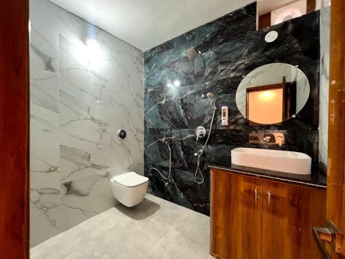 a bathroom with a sink and a mirror at Hotel Dream Inn Khajuraho in Khajurāho