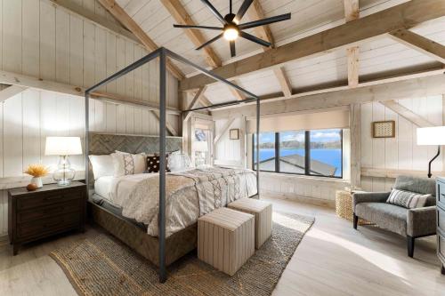 a bedroom with a canopy bed and a chair at Keenan Beach w/Beach, Heated Pool & Game Room in Mooresville