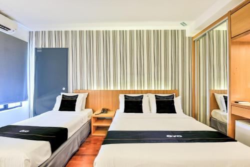 a hotel room with two beds and a window at Sunday Malacca Near Jonker Street Formerly Quayside in Melaka