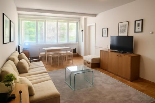a living room with a couch and a table at ML Apartman in Belgrade