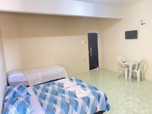 a hospital room with a bed and a table at Hotel Renascer pojuca in Pojuca