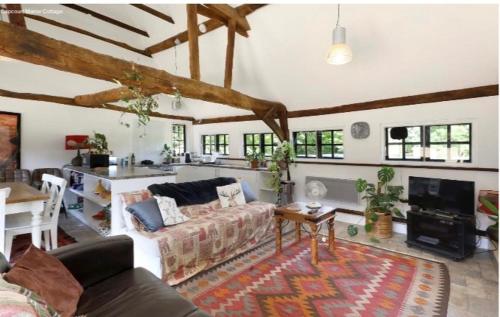 a living room with a couch and a table at The Thatched Barn in Thame