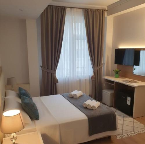 a bedroom with a bed with two towels at Çelik Crown Hotel in Trabzon