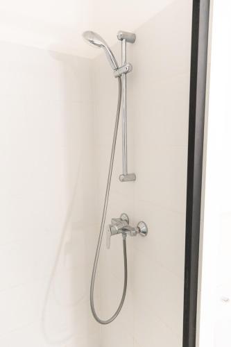 a shower in a bathroom with a shower head at Studio à Disneyland Paris in Coupvray