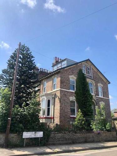 a large brick house on the side of a street at The Garden Room YORK in York