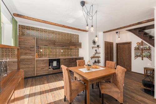 a dining room with a wooden table and a fireplace at doLodge homestead in the Kolpa River canyon in Stari Trg ob Kolpi