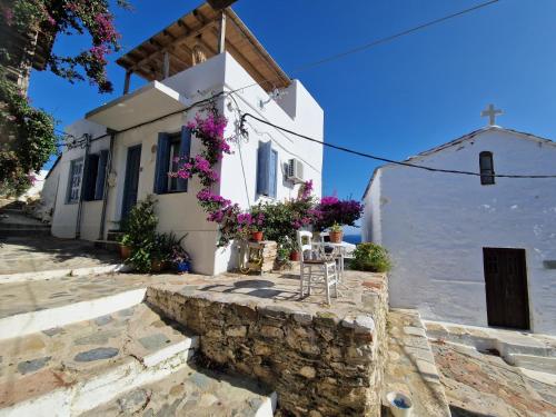 una iglesia con una mesa y sillas frente a ella en Peppermint Bay, en Skopelos Town