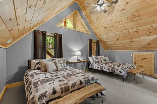 a bedroom with two beds and a ceiling at Bear Necessities in Beech Mountain