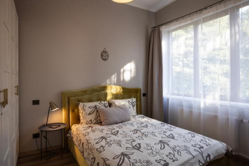 a bedroom with a bed and a window at SunCoast terrace apartment in Saulkrasti
