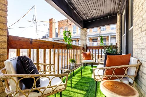 a patio with chairs and tables on a balcony at Prime Location Top Rated Clean Parking Free! in Columbus