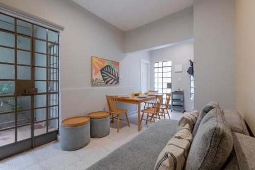 a living room with a couch and a table at Kin Pech Roma by Capitalia in Mexico City