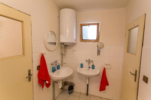 a bathroom with two sinks and a mirror at Cyklochata in Vranov nad Dyjí
