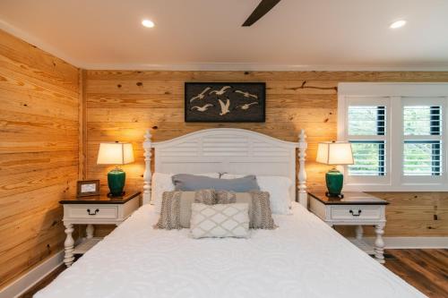 a bedroom with a white bed with two night stands at T-Time in Edisto Island
