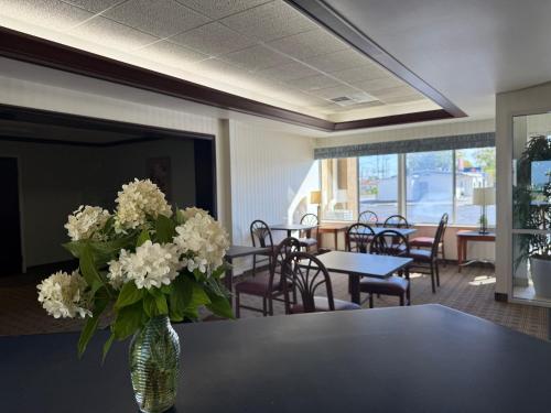 a vase of white flowers sitting on a table at Clinton Inn & Suites in Port Clinton