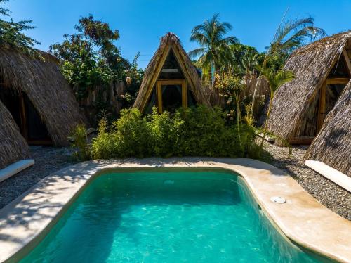 a swimming pool in front of a resort at Villa Privada Merkaba Pxm in Brisas de Zicatela
