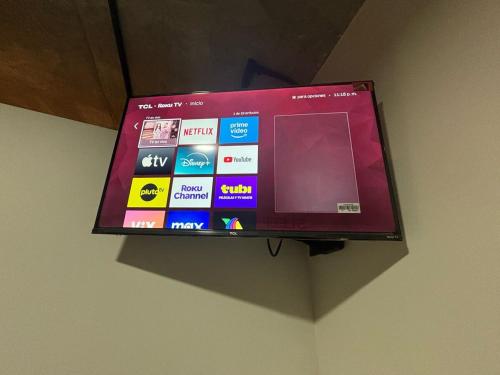a flat screen tv hanging on a wall at Travel VIP Lounge Themed Stay with Private Parking in Monterrey