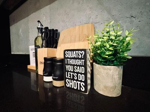 a table with a potted plant and a sign on it at Travel VIP Lounge Themed Stay with Private Parking in Monterrey