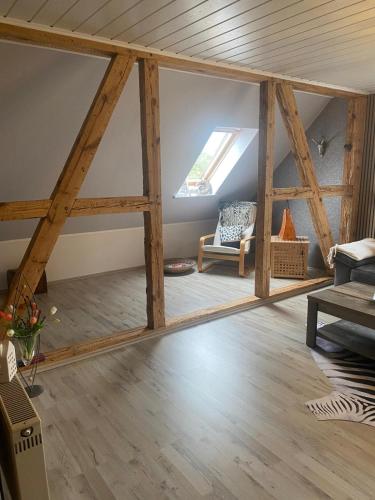 a living room with wooden beams and a window at Haus Sommerfeld 
