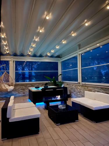 a living room with couches and a piano at Artemide Resort Spa - Private Villa in Lido Di Fondi