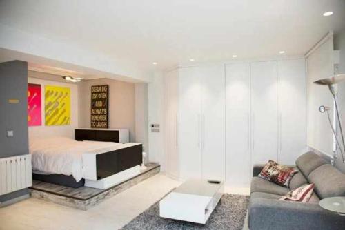 una sala de estar con una cama y un sofá en Loft San Francisco 26, en Pamplona