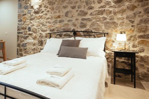 a bedroom with a bed with towels on it at Filoxenion in Nafplio